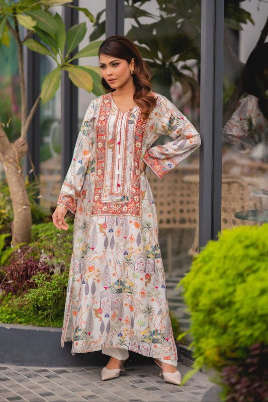 Woman in a floral dress standing outdoors with greenery in the background